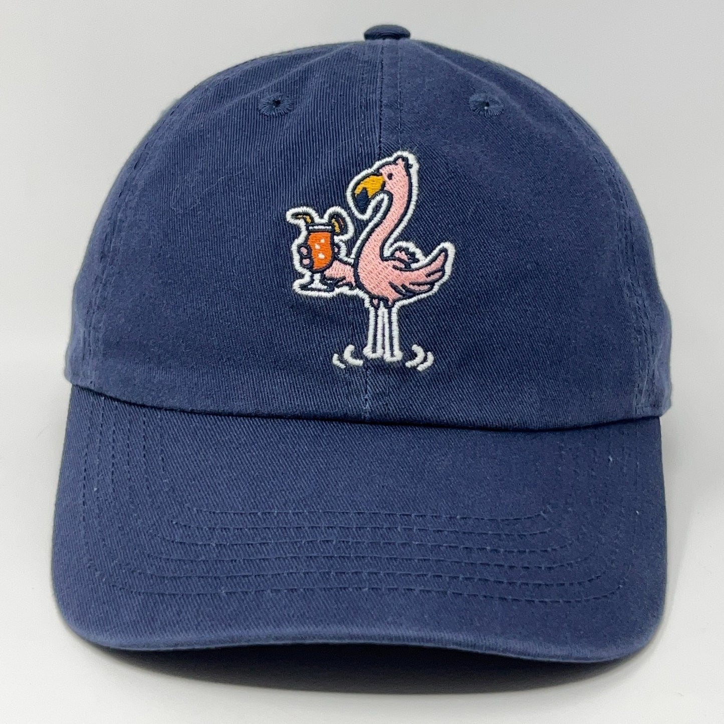 Navy Life Is Good cap featuring a pink flamingo holding a drink, front view