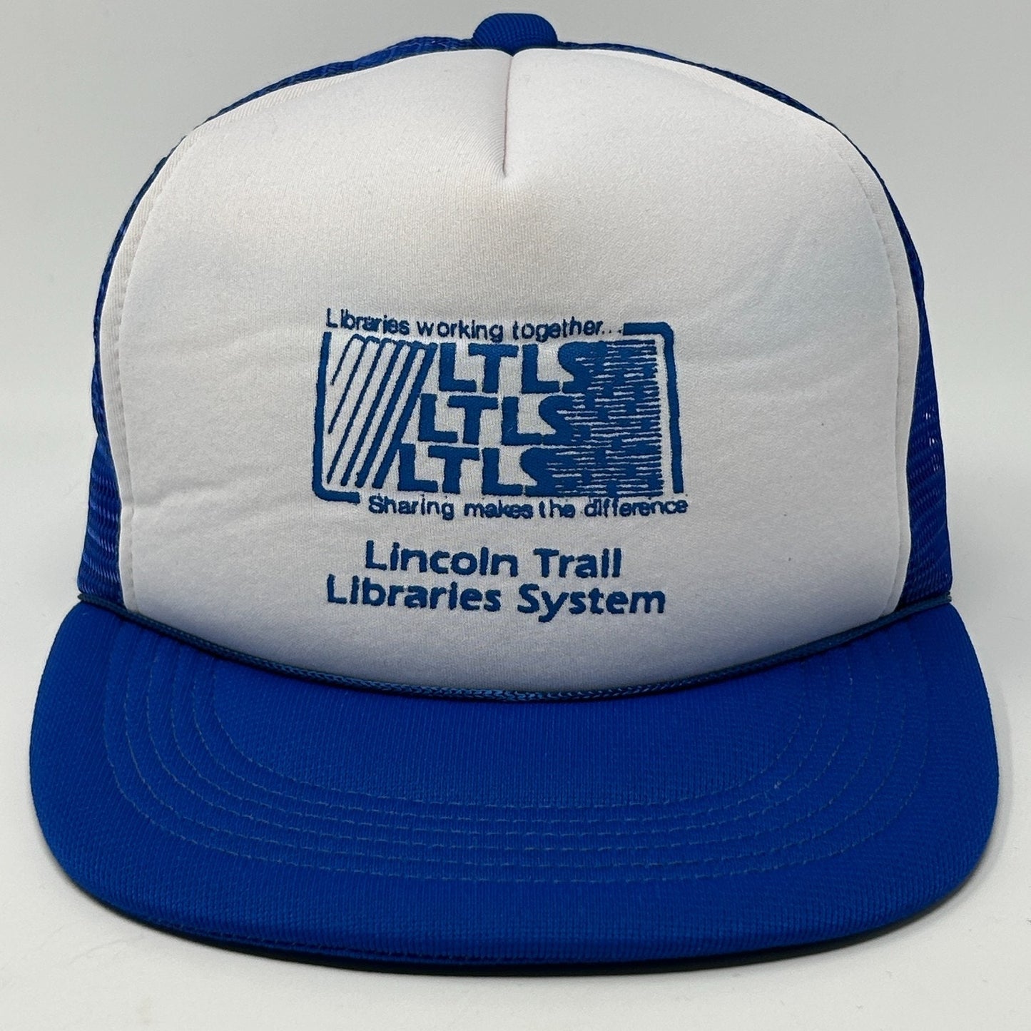 Front view of a vintage blue hat with Lincoln Trail Libraries System logo, featuring Illinois details