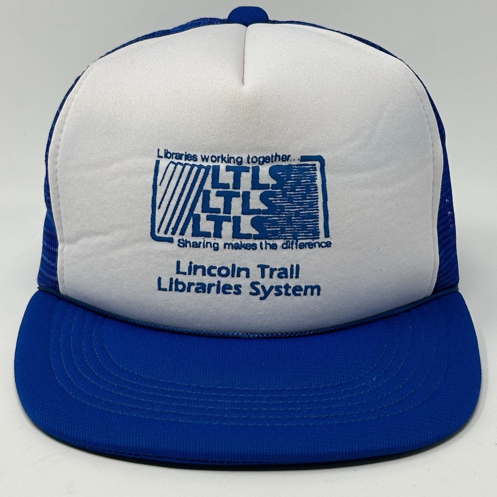 Front view of a vintage blue hat with Lincoln Trail Libraries System logo, featuring Illinois details