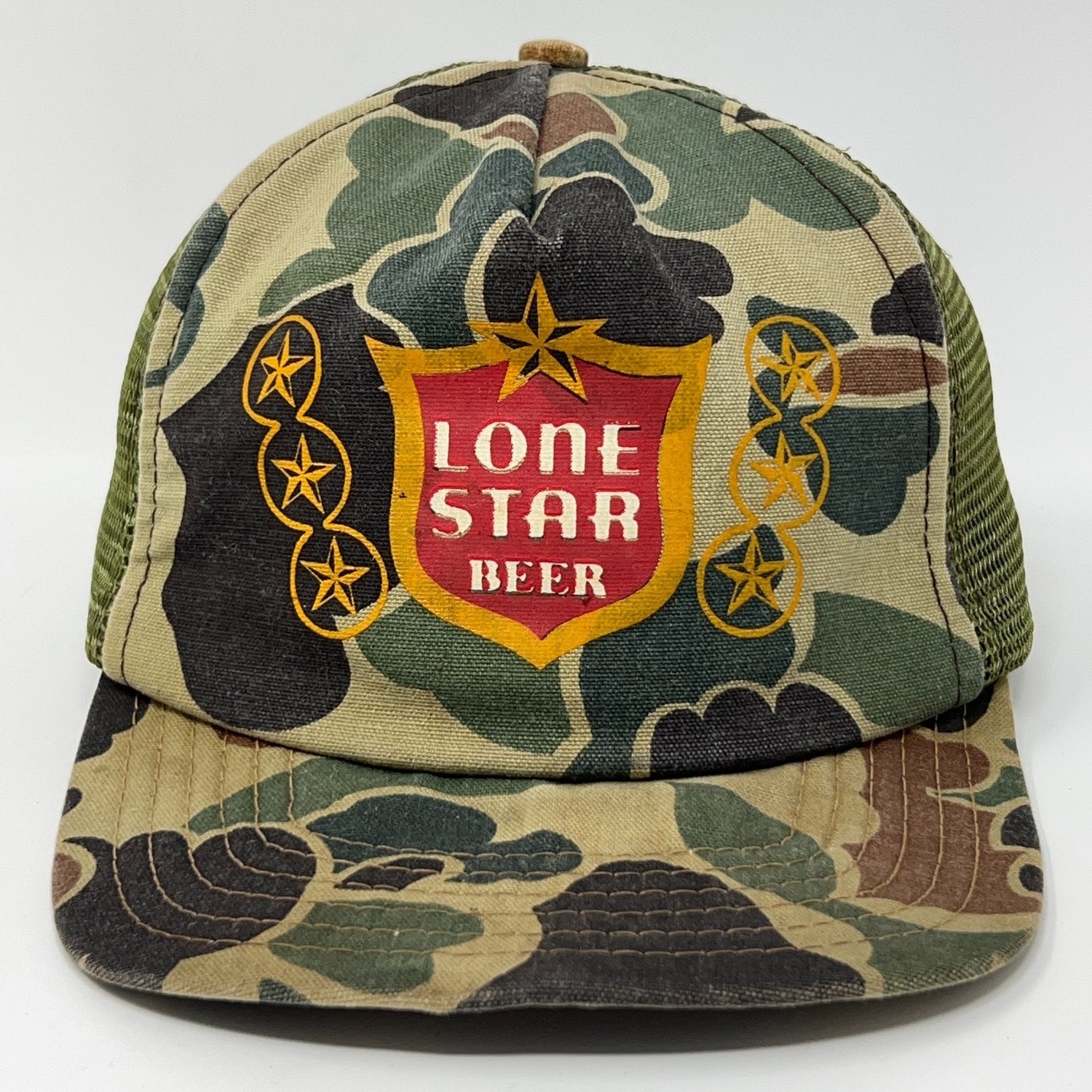 Vintage camouflage cap featuring a bold Lone Star Beer logo on the front in red and yellow