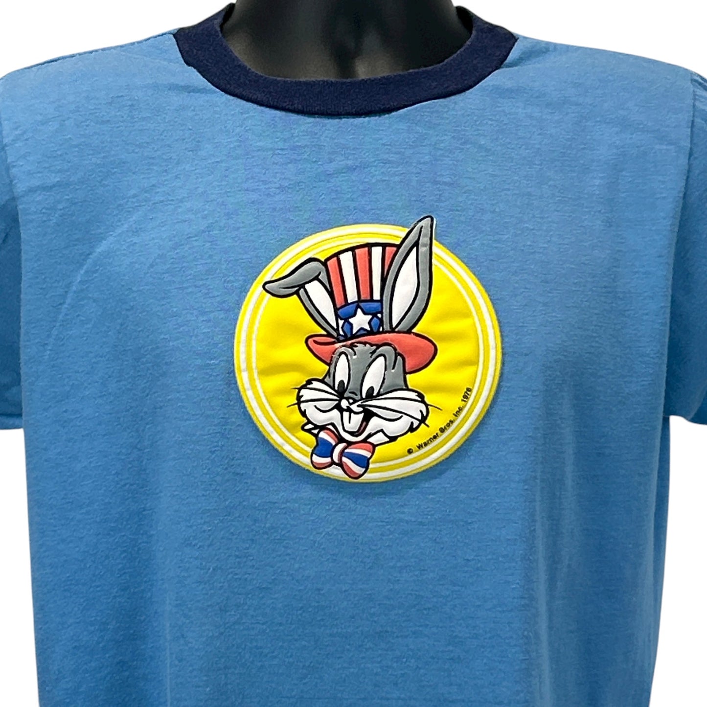 Vintage blue T-shirt featuring Bugs Bunny graphic on the front with a round logo