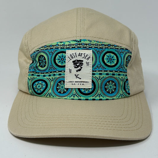 Lost Enterprises Hat in tan with patterned front panel featuring blue and green designs and logo