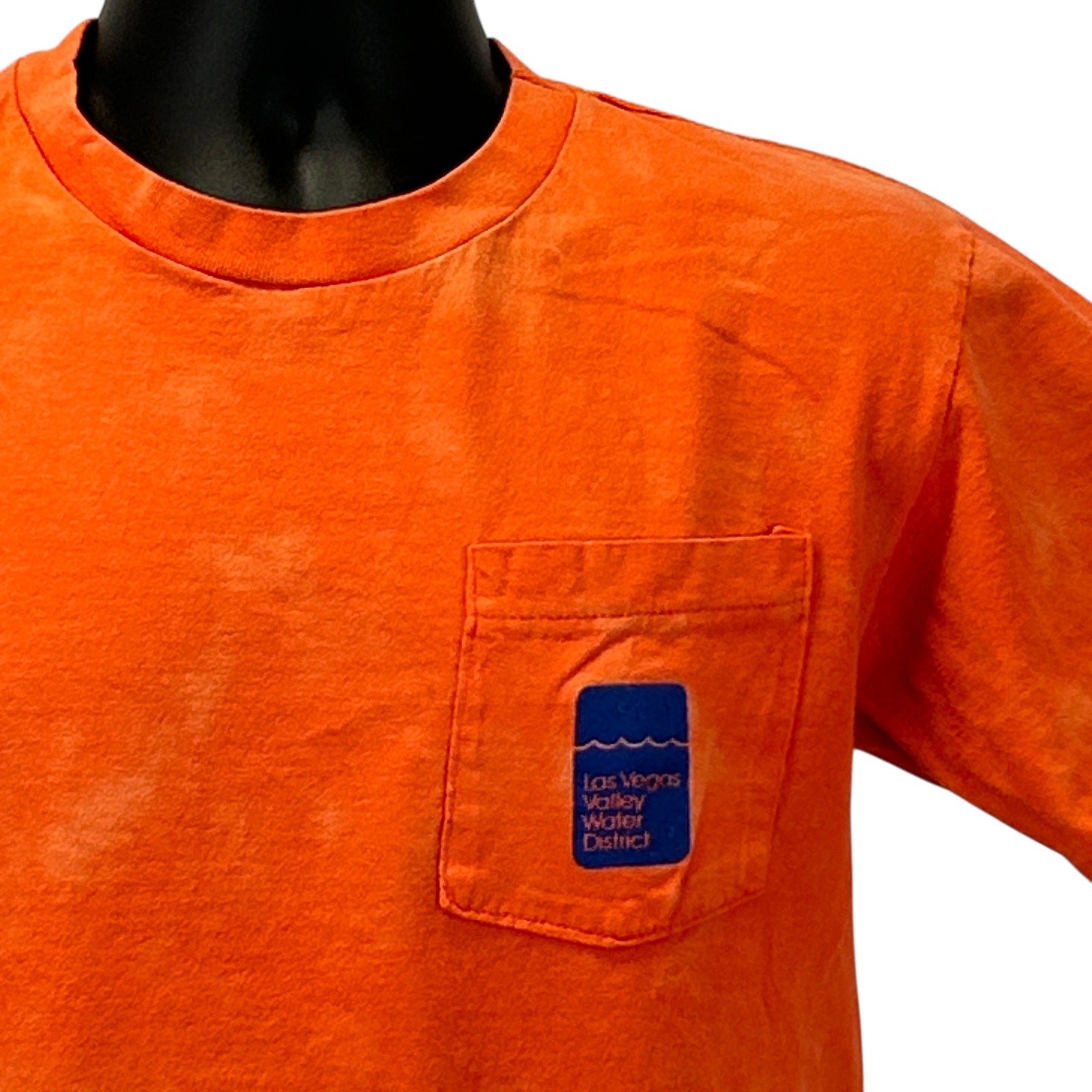 Anvil orange T-shirt featuring a front pocket with Las Vegas Valley Water District logo.