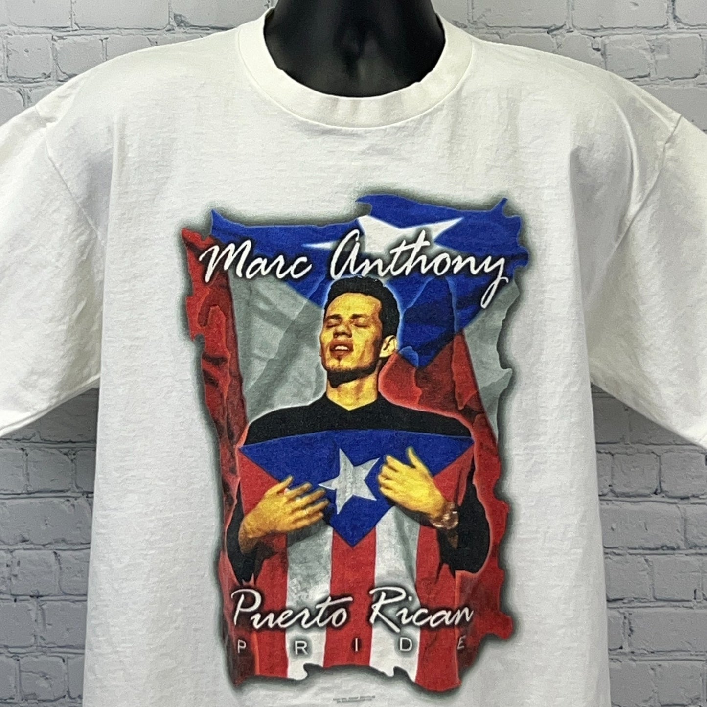 White Marc Anthony T-shirt featuring a Puerto Rican Pride graphic in vibrant colors, front view