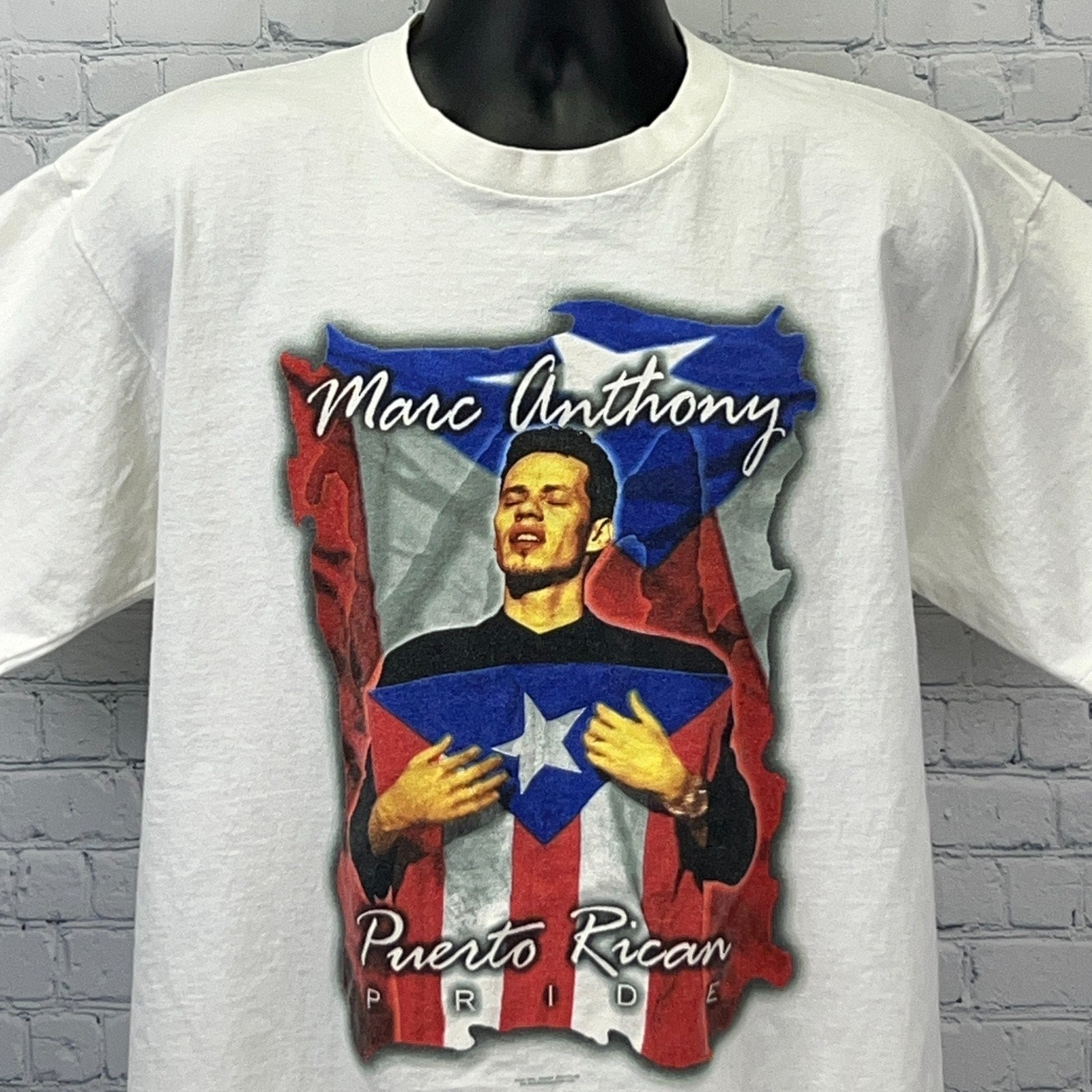 White Marc Anthony T-shirt featuring a Puerto Rican Pride graphic in vibrant colors, front view