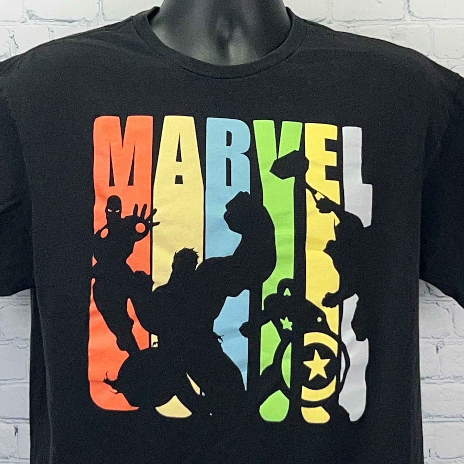 Black Marvel Comics T-shirt featuring iconic superhero silhouettes in colorful retro design