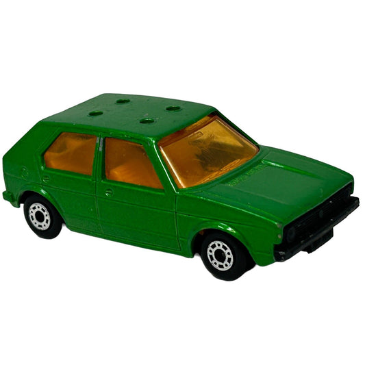 Green Matchbox toy car model with orange windows, front view showcasing compact design and detailed wheels
