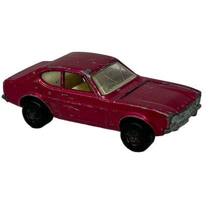 Vintage Matchbox toy car in maroon color with detailed body design and worn paint, featuring black wheels