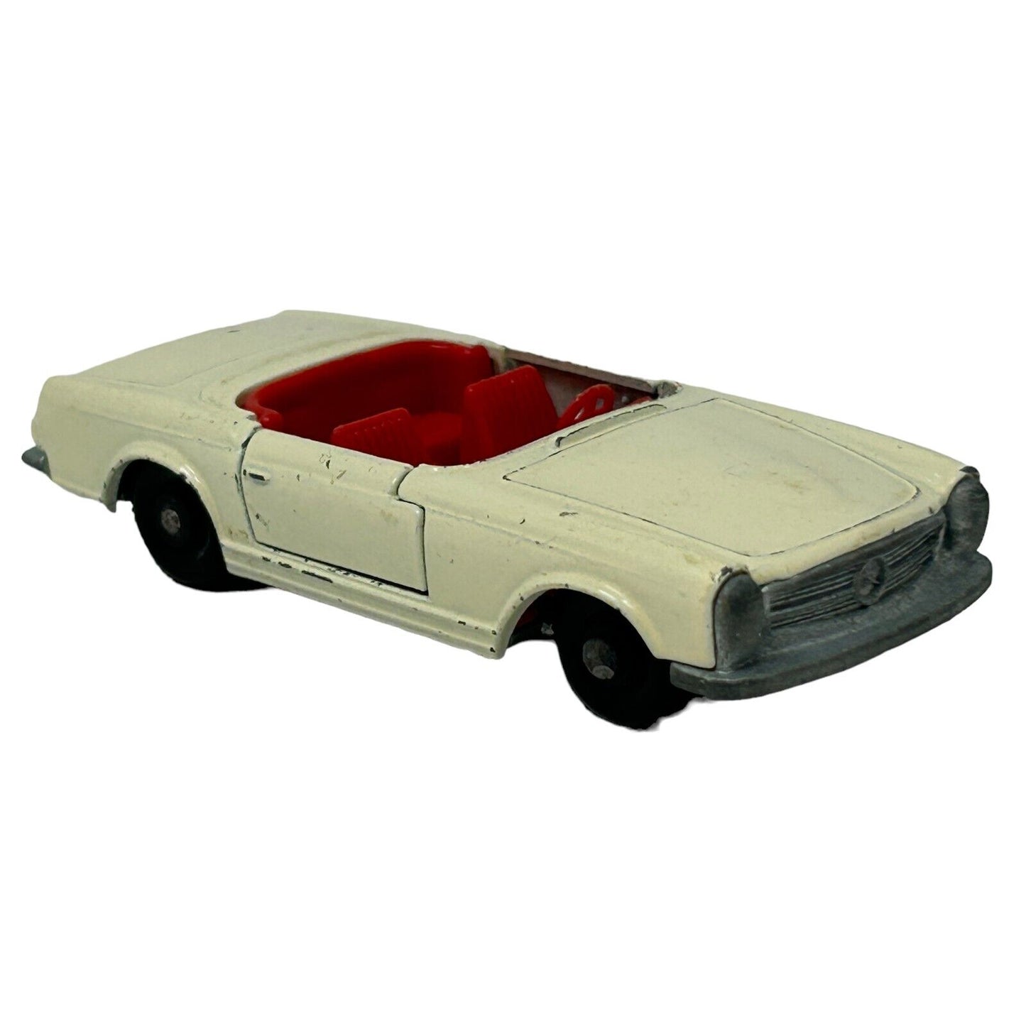 Matchbox vintage white convertible car with red interior, showing front view and detailed design