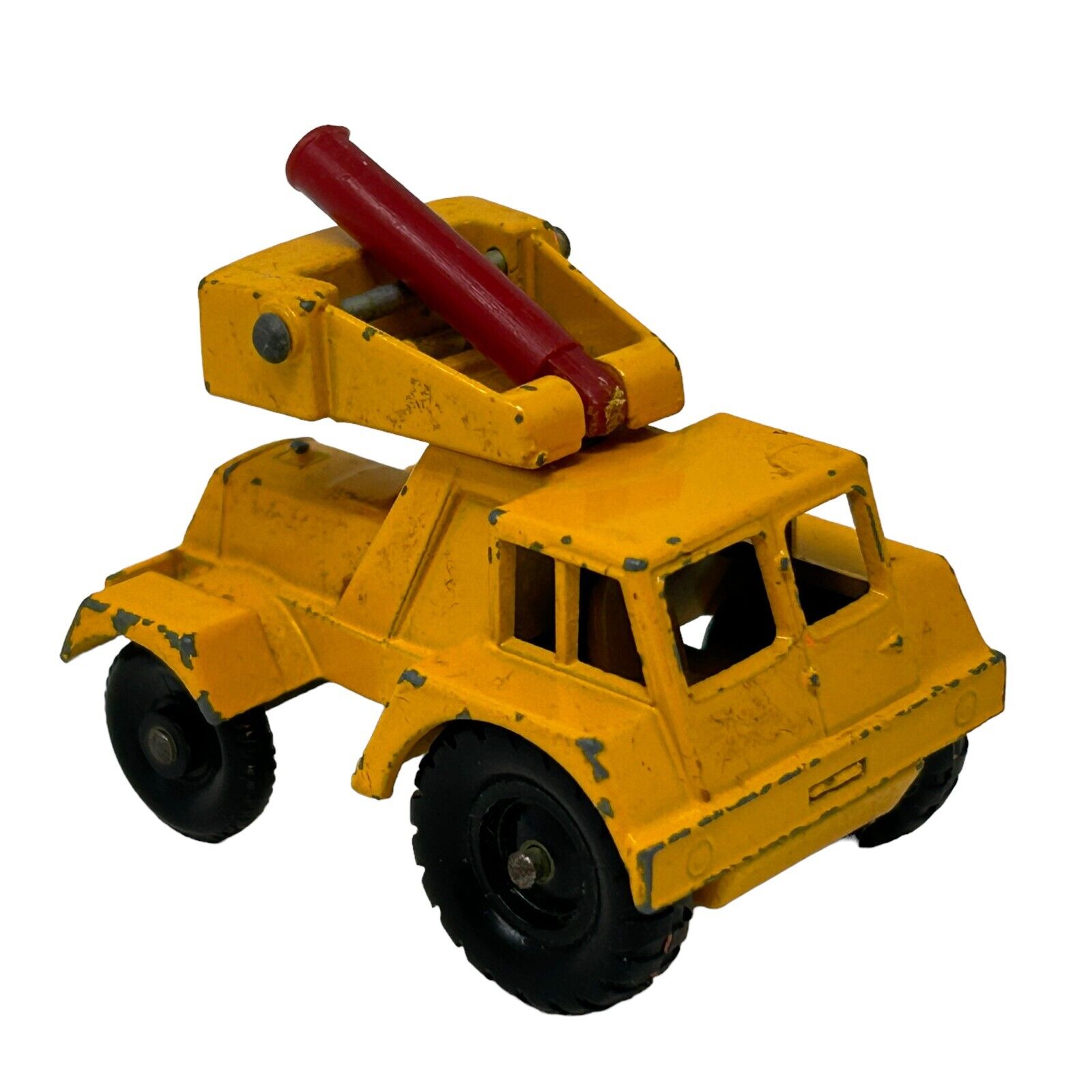 Vintage Matchbox yellow tow truck toy with red tow arm, front view, compact size, showing wear marks