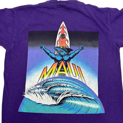Purple Maui and Sons T-Shirt featuring a graphic of a surfer with a wave on the back