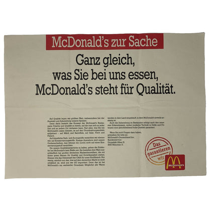 McDonald's promotional banner in beige and red featuring a quality message and logo