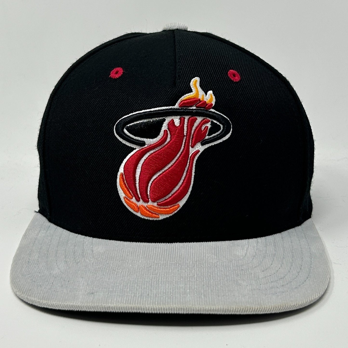 Front view of black Mitchell & Ness Miami Heat Hat featuring embroidered logo and gray brim