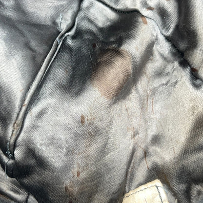 Vintage military helmet in black with a worn interior view