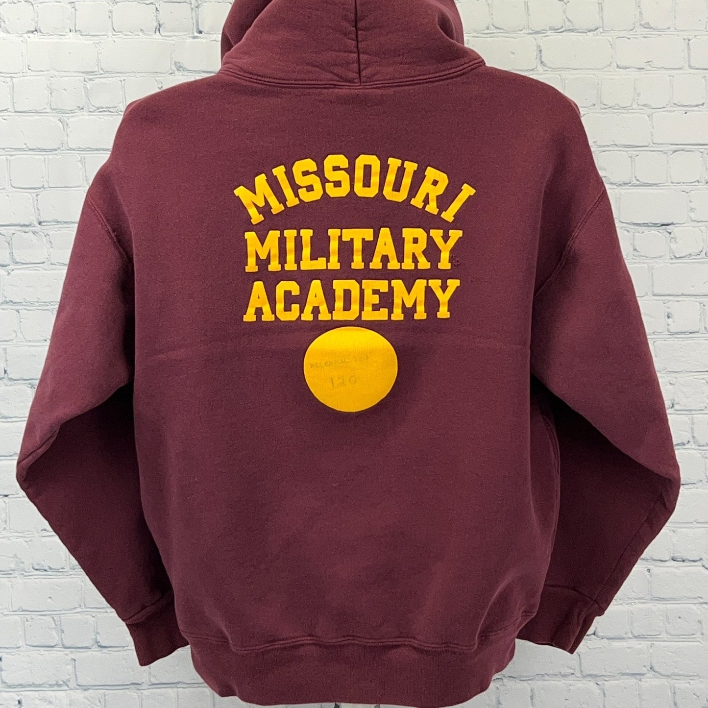 Maroon hoodie from The Cotton Exchange featuring the Missouri Military Academy logo on the back