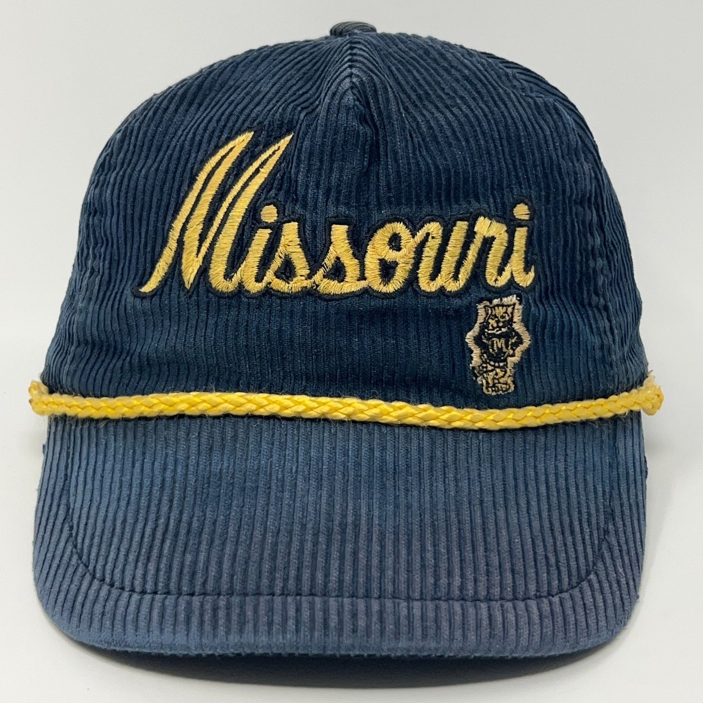 Front view of a navy blue corduroy cap with Missouri Tigers embroidered in gold and a state logo