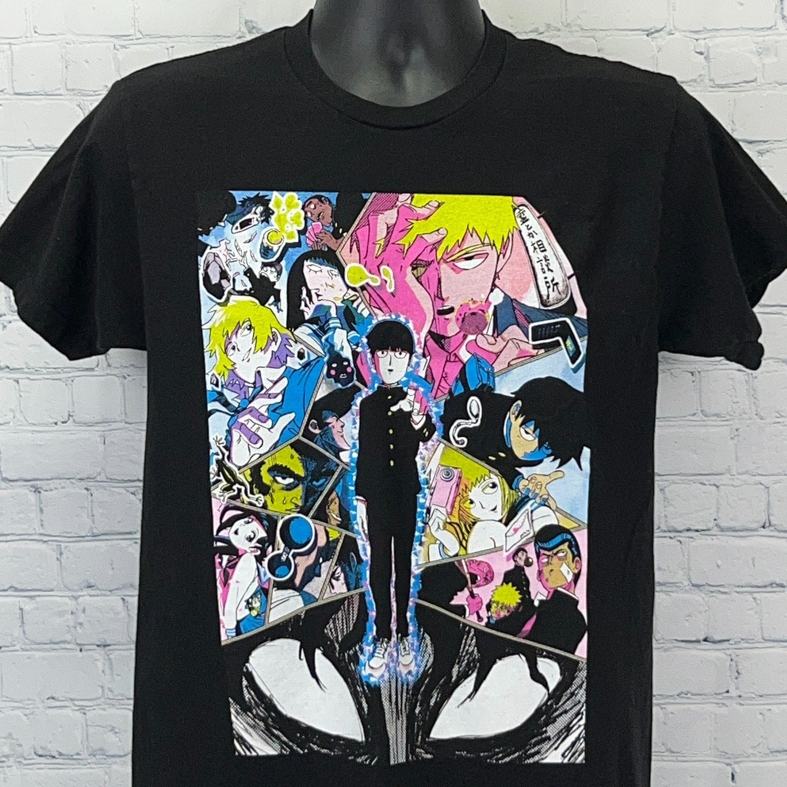 Black Mob Psycho 100 T-shirt featuring colorful graphic design of characters on the front