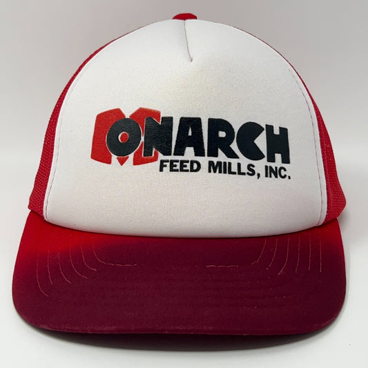 Red and white vintage trucker hat featuring Monarch Feed Mills logo on the front