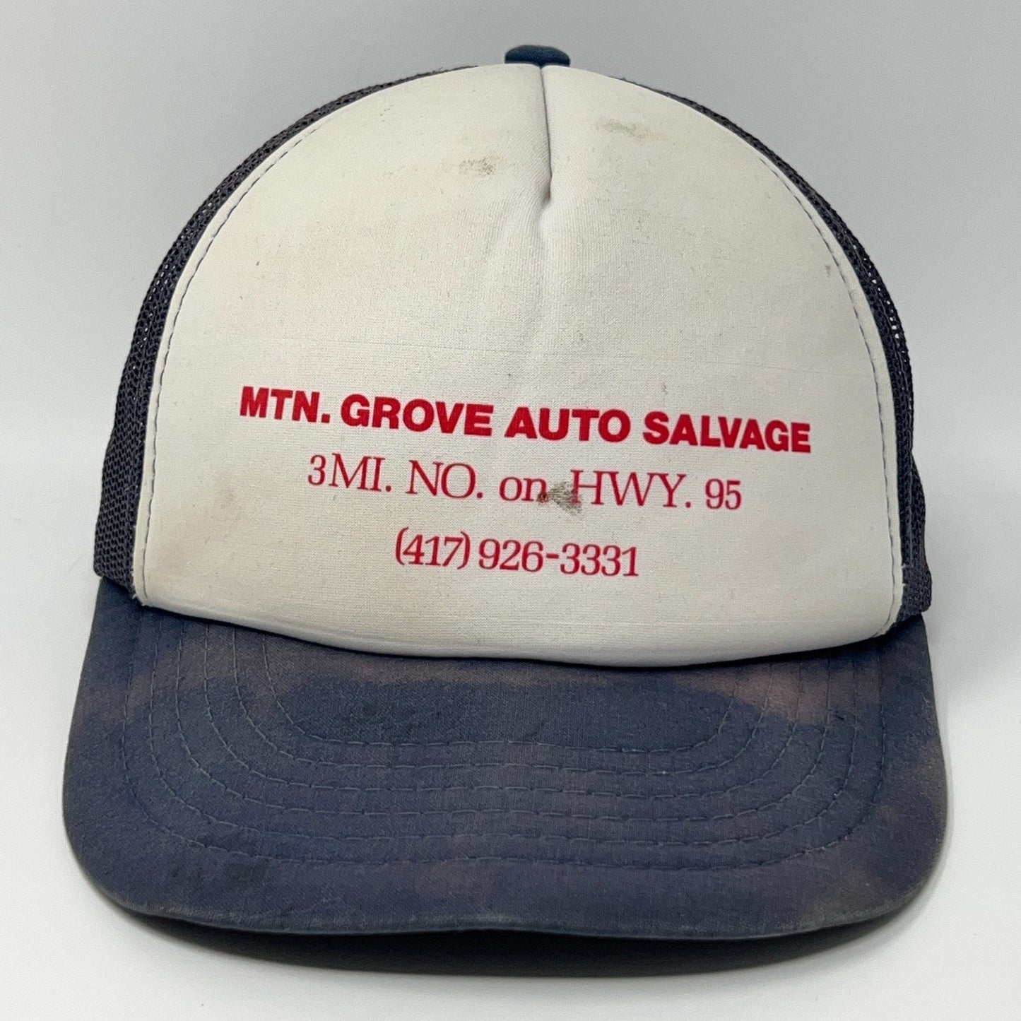 Front view of a Vintage Trucker Hat in white and navy with MTN. GROVE AUTO SALVAGE logo and contact details