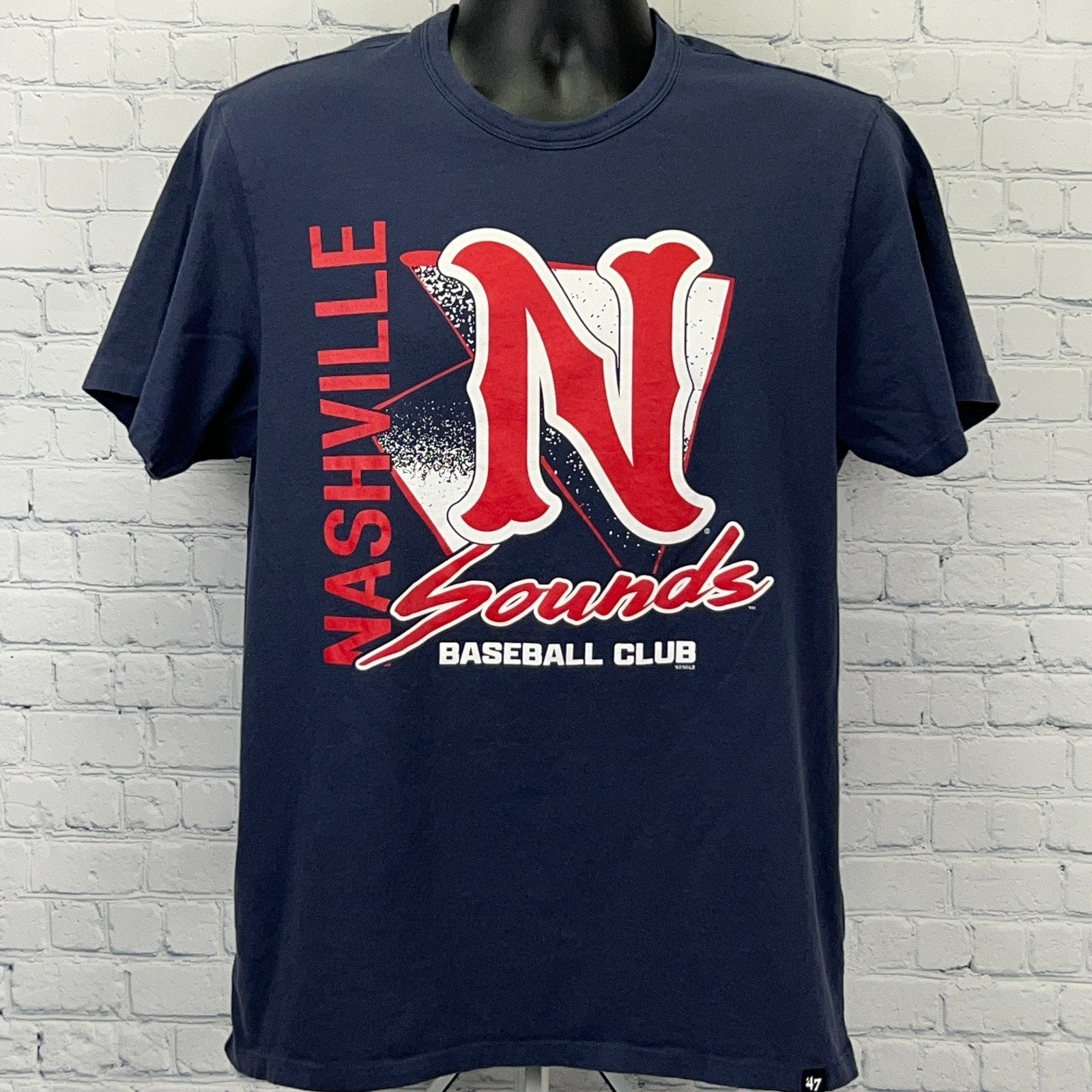 Navy blue Nashville Sounds T-shirt featuring a bold red logo with the team name and club detail