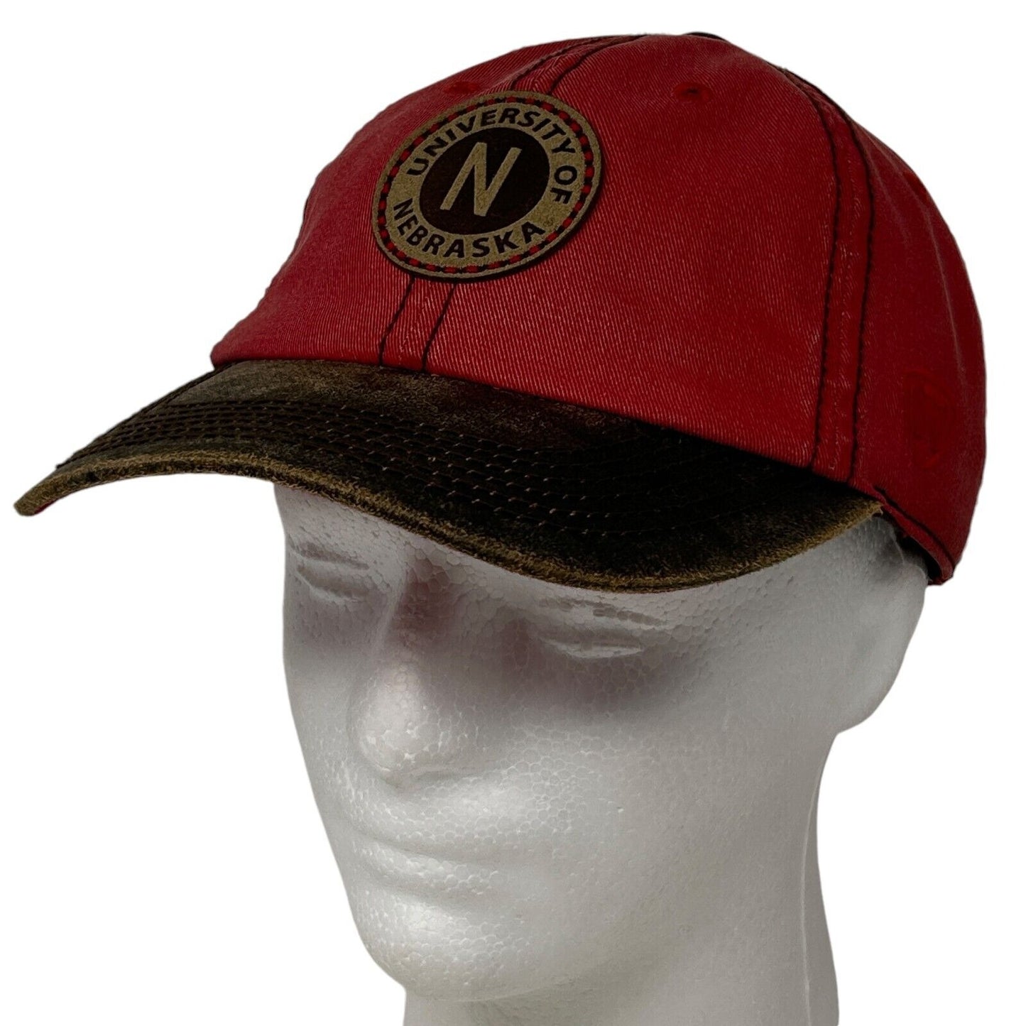 Nebraska Cornhuskers red cap with a circular logo featuring the letter N on the front view