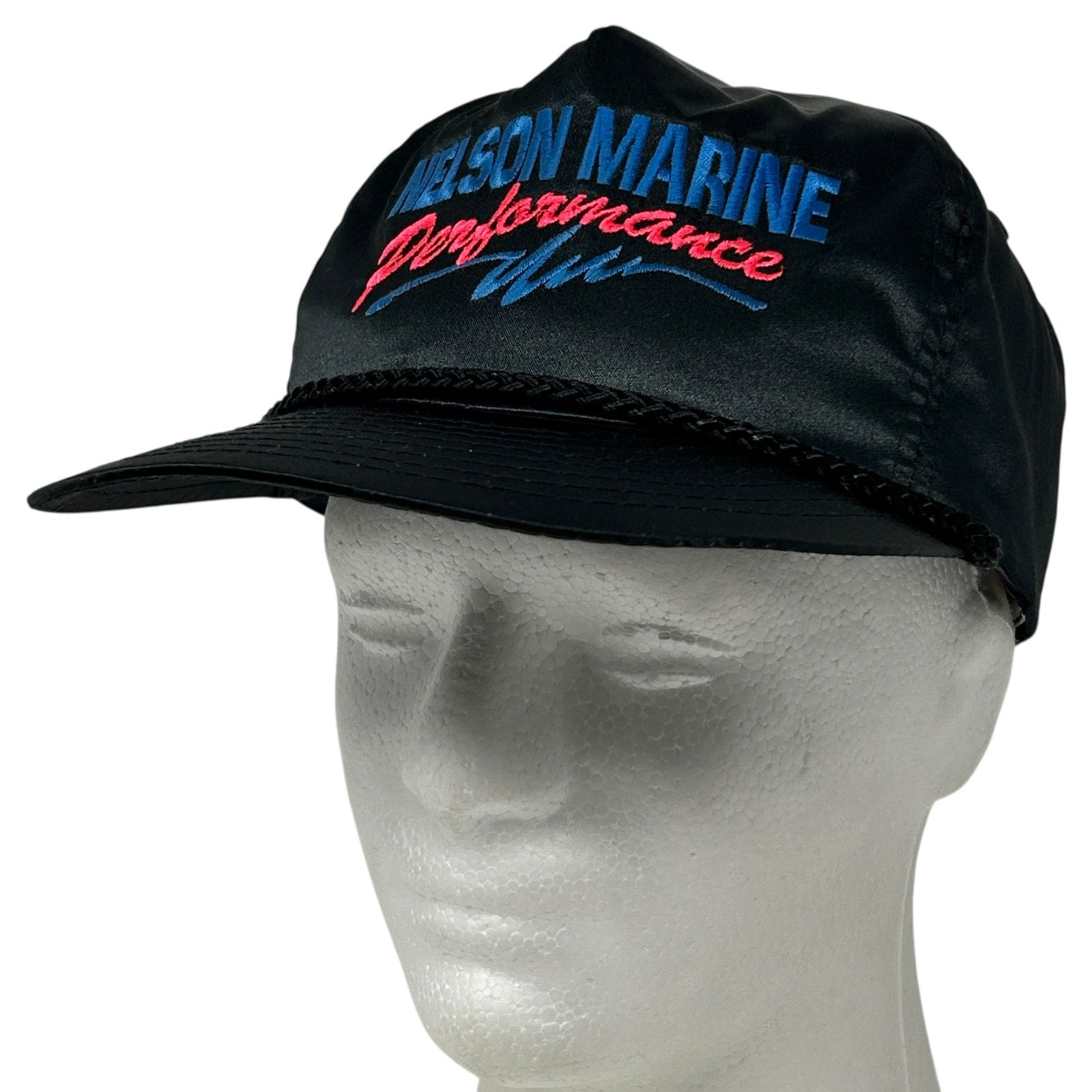 Black Nissin cap featuring 'NELSON MARINE' logo on the front, ideal for outdoor activities.