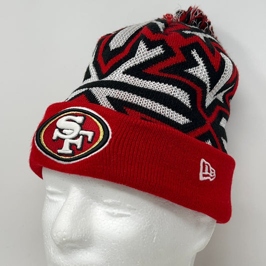 Red New Era 49ers beanie with black and silver patterns and logo on the front for winter warmth