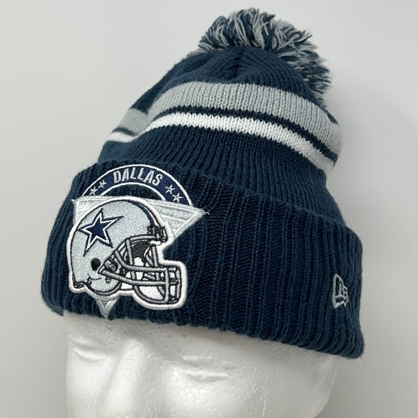 Dallas Cowboys navy knit beanie with team logo and pom-pom on top for winter wear