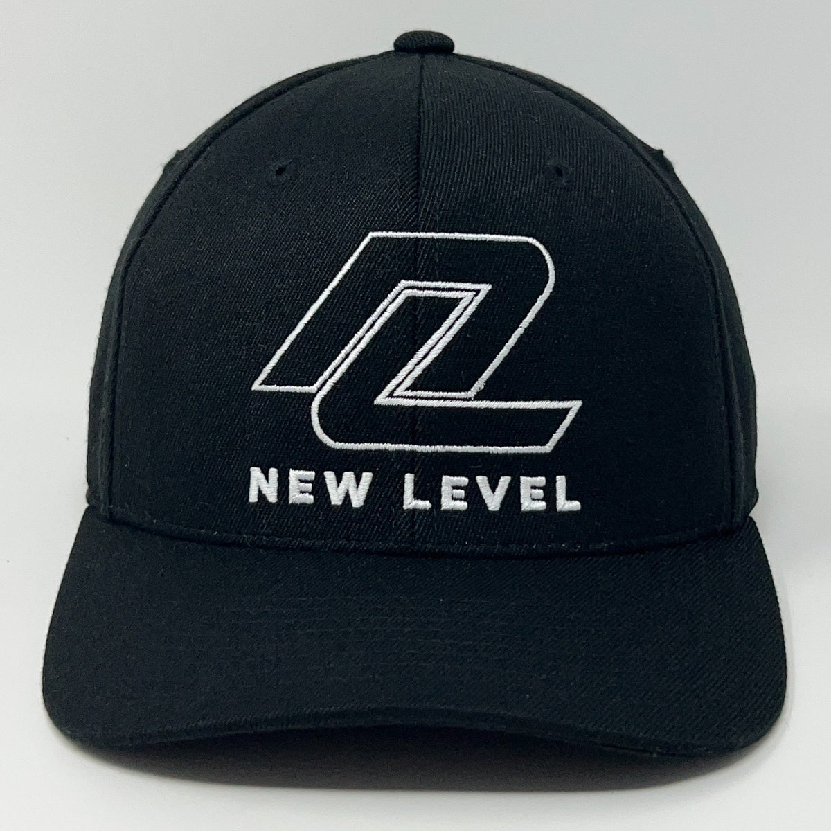 Black Yupoong cap with white embroidered New Level Golf logo on the front view
