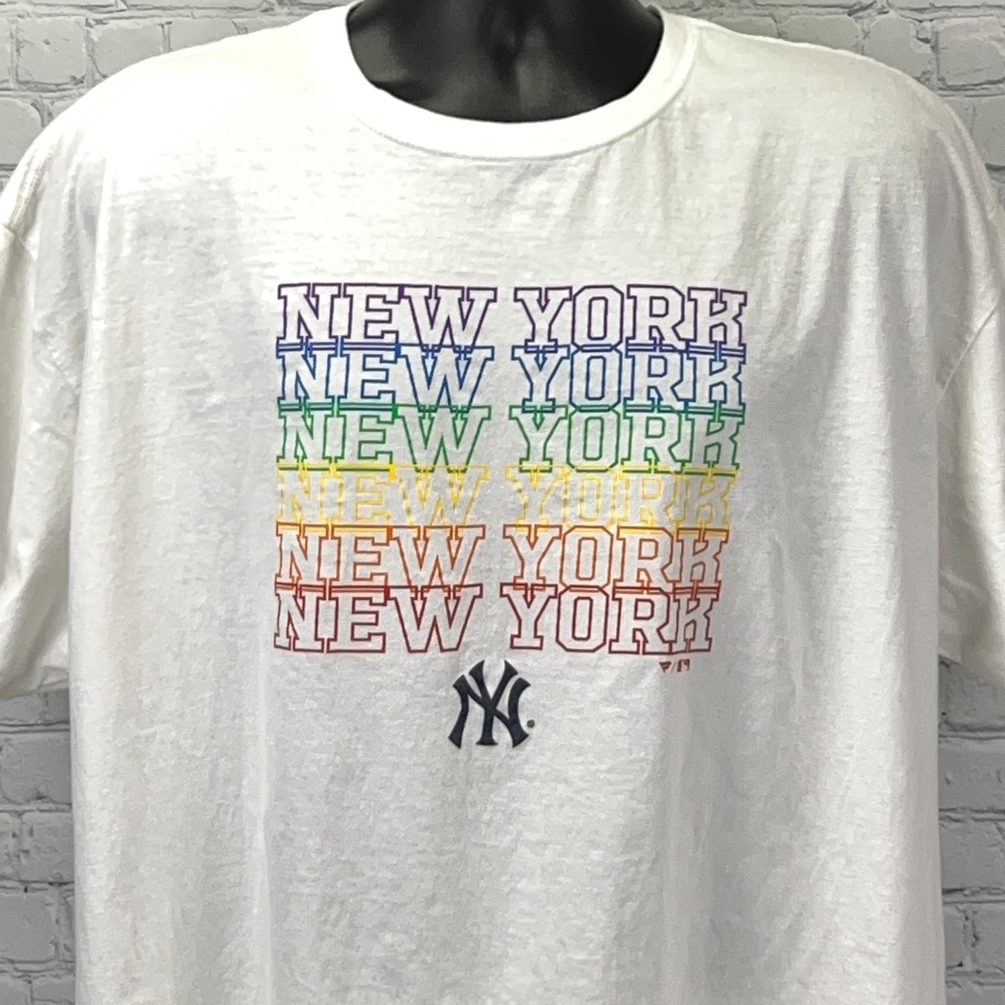 White New York Yankees T-shirt featuring colorful stacked lettering and logo on the front.