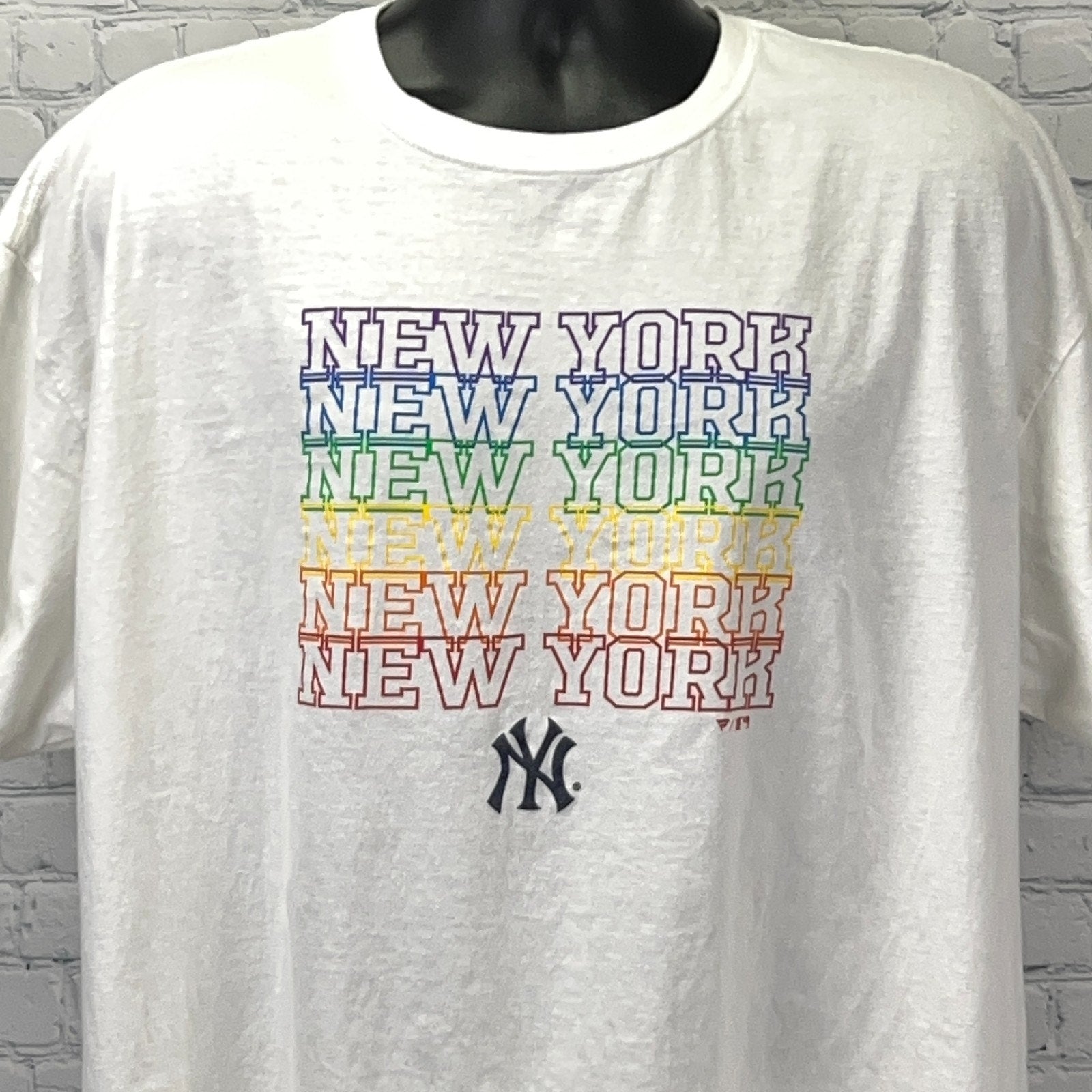 White New York Yankees T-shirt featuring colorful stacked lettering and logo on the front.