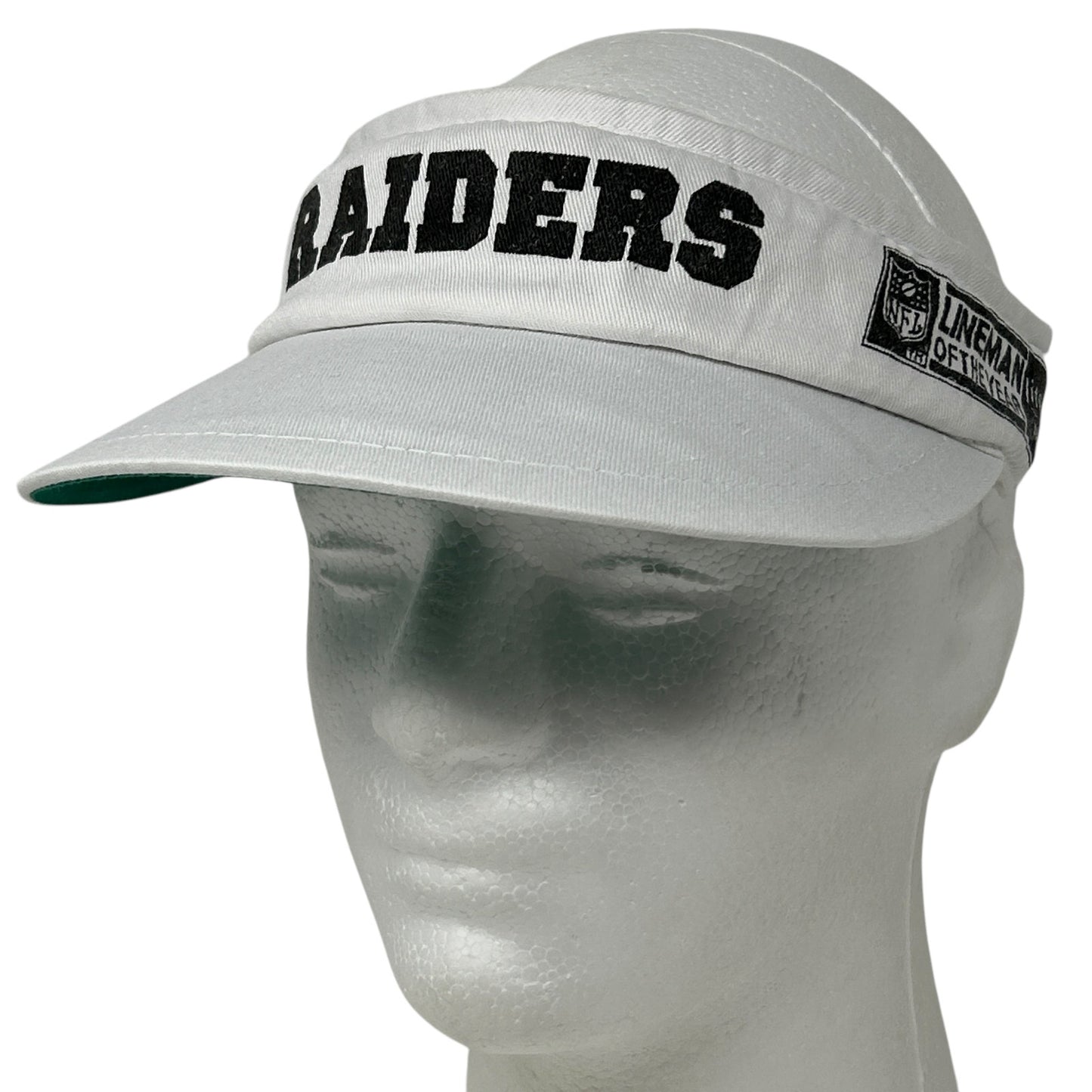 Gray Vintage Las Vegas Raiders visor hat with bold logo and adjustable strap, front view.