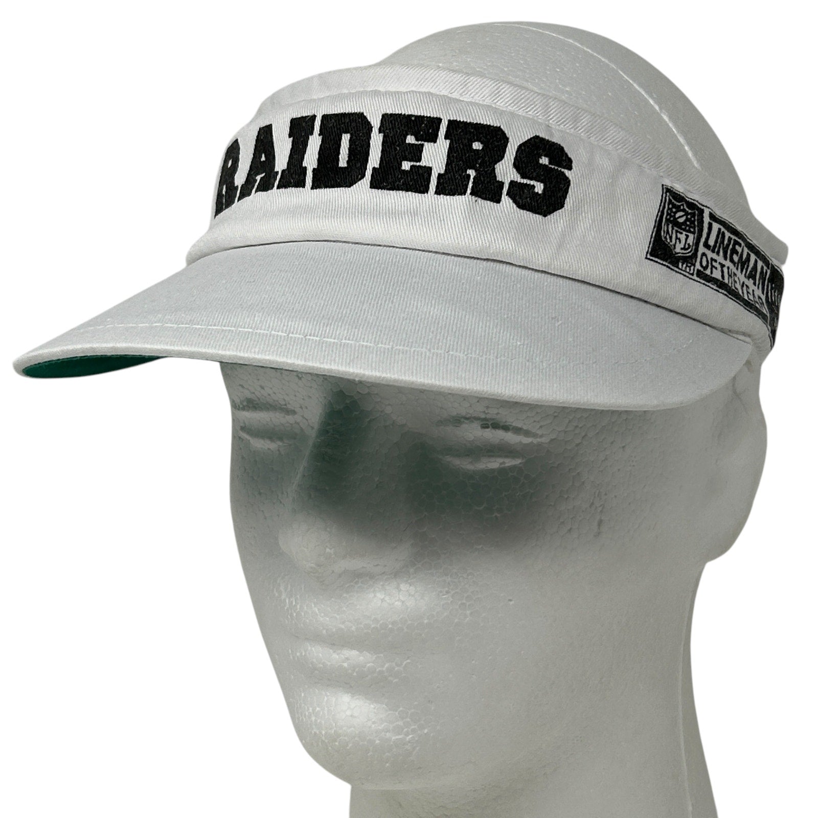 Gray Vintage Las Vegas Raiders visor hat with bold logo and adjustable strap, front view.