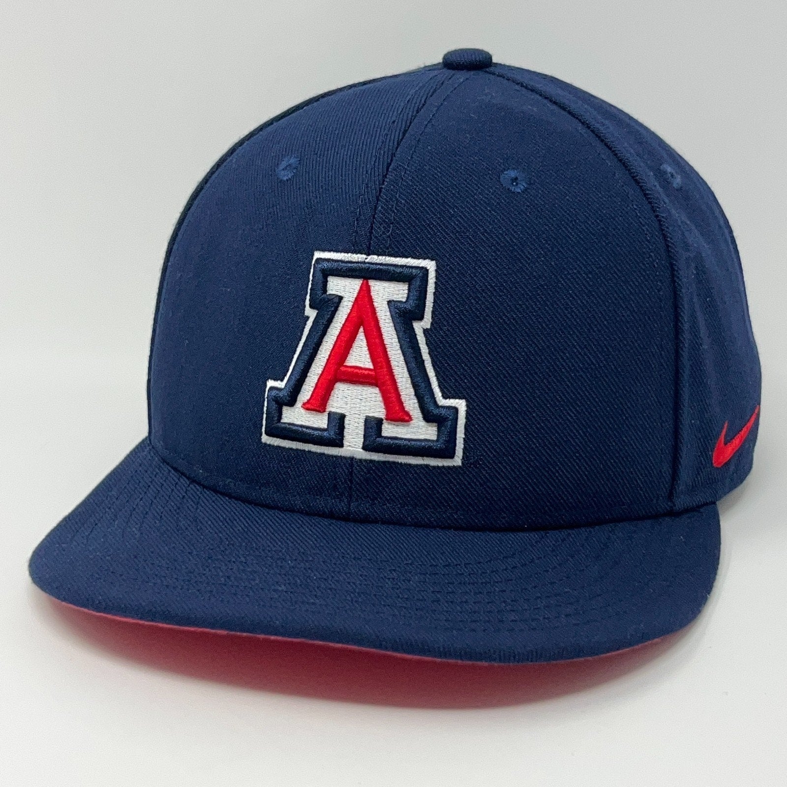 Navy blue Nike Arizona Wildcats cap featuring logo on front with red accents and flat brim