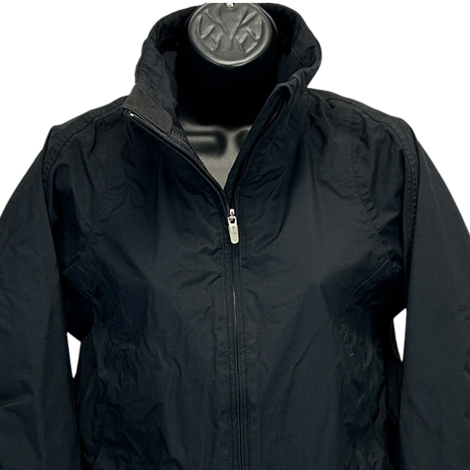 Nike black jacket close-up front view with zipper and subtle logo details