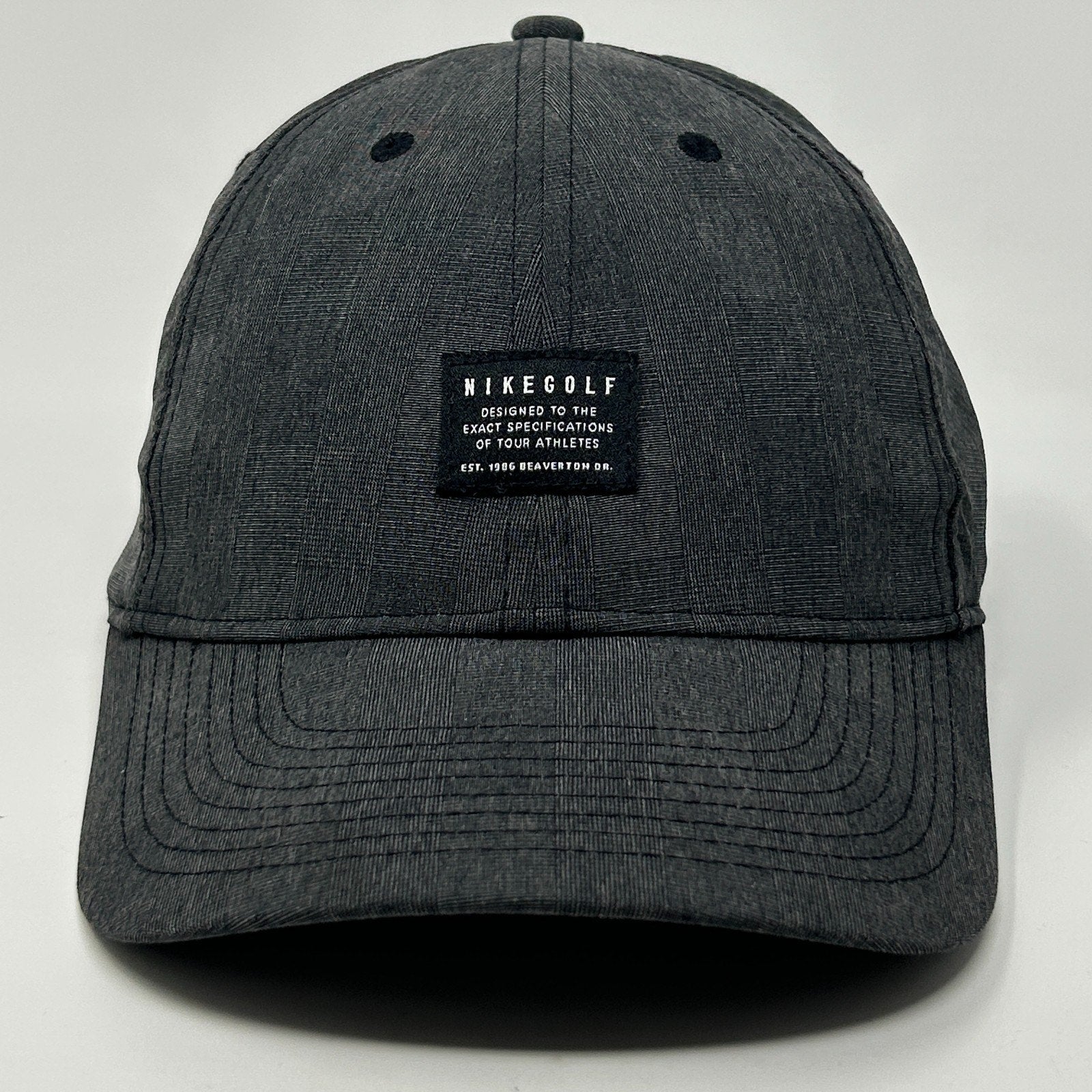 Nike Golf Hat in dark gray with front logo patch and curved brim for casual wear
