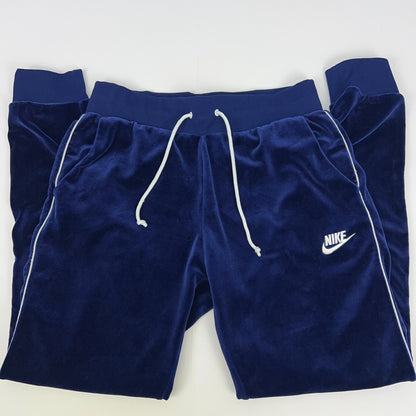 Nike navy blue velour sweatpants with white drawstrings and logo, front view