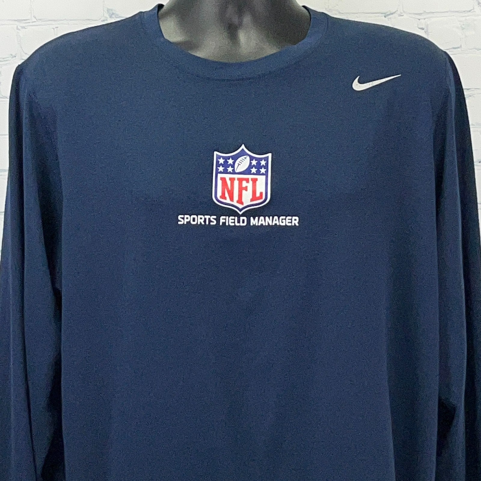 Navy Nike NFL long sleeve shirt featuring 'Sports Field Manager' logo on the front