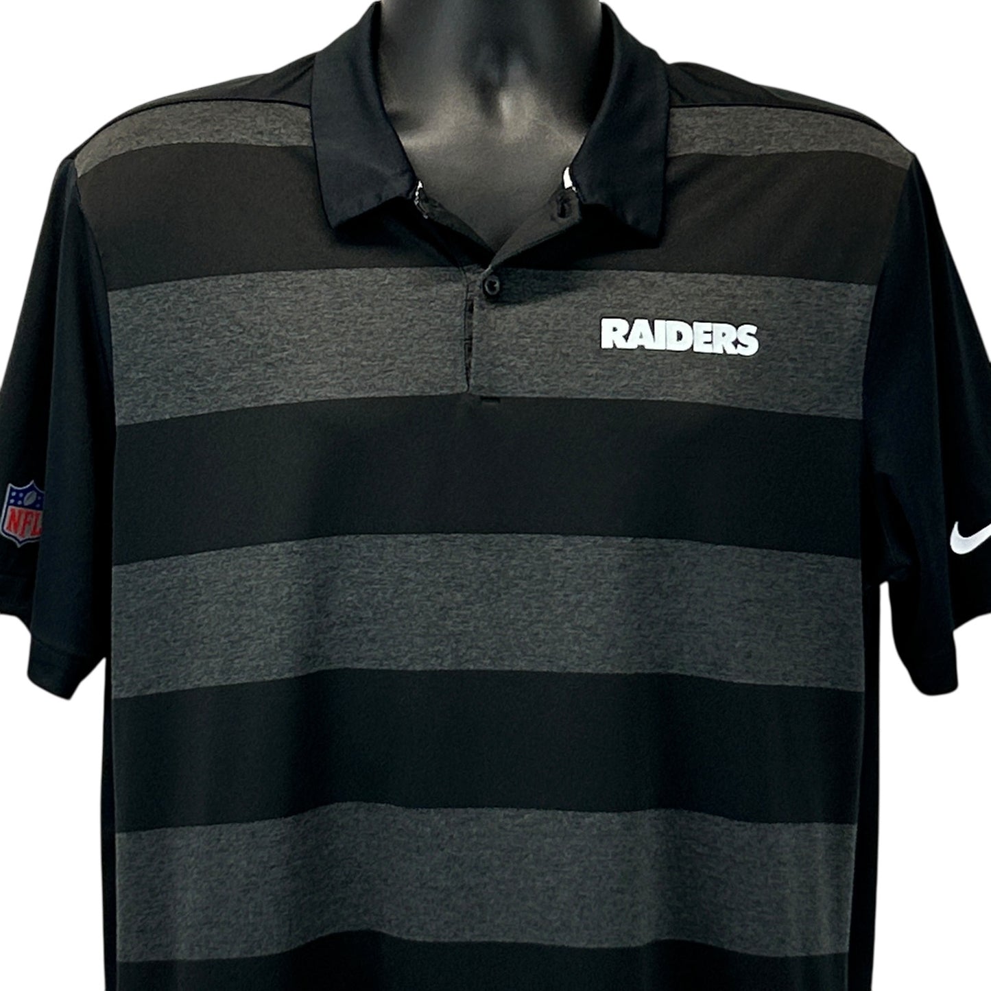 Nike Raiders Polo in black and gray stripes with front logo, perfect for fans and casual wear.