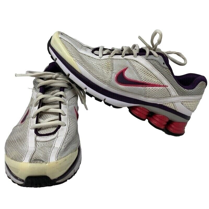 Nike Shox running shoes in gray and purple with a unique cushioned sole and logo detail