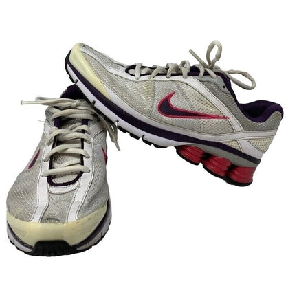 Nike Shox running shoes in gray and purple with a unique cushioned sole and logo detail