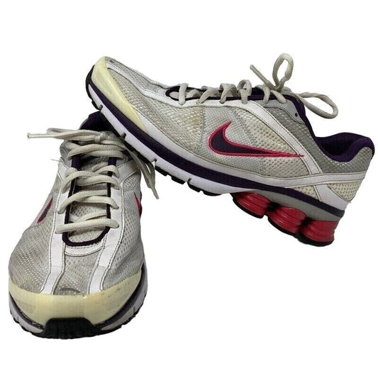 Nike Shox running shoes in gray and purple with a unique cushioned sole and logo detail
