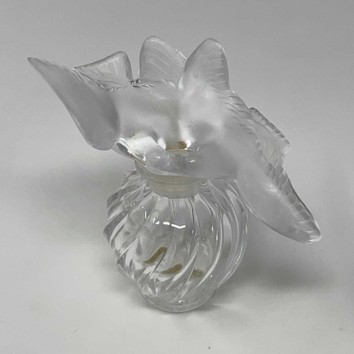 Nina Ricci floral glass perfume bottle with a frosted two doves top, viewed from above