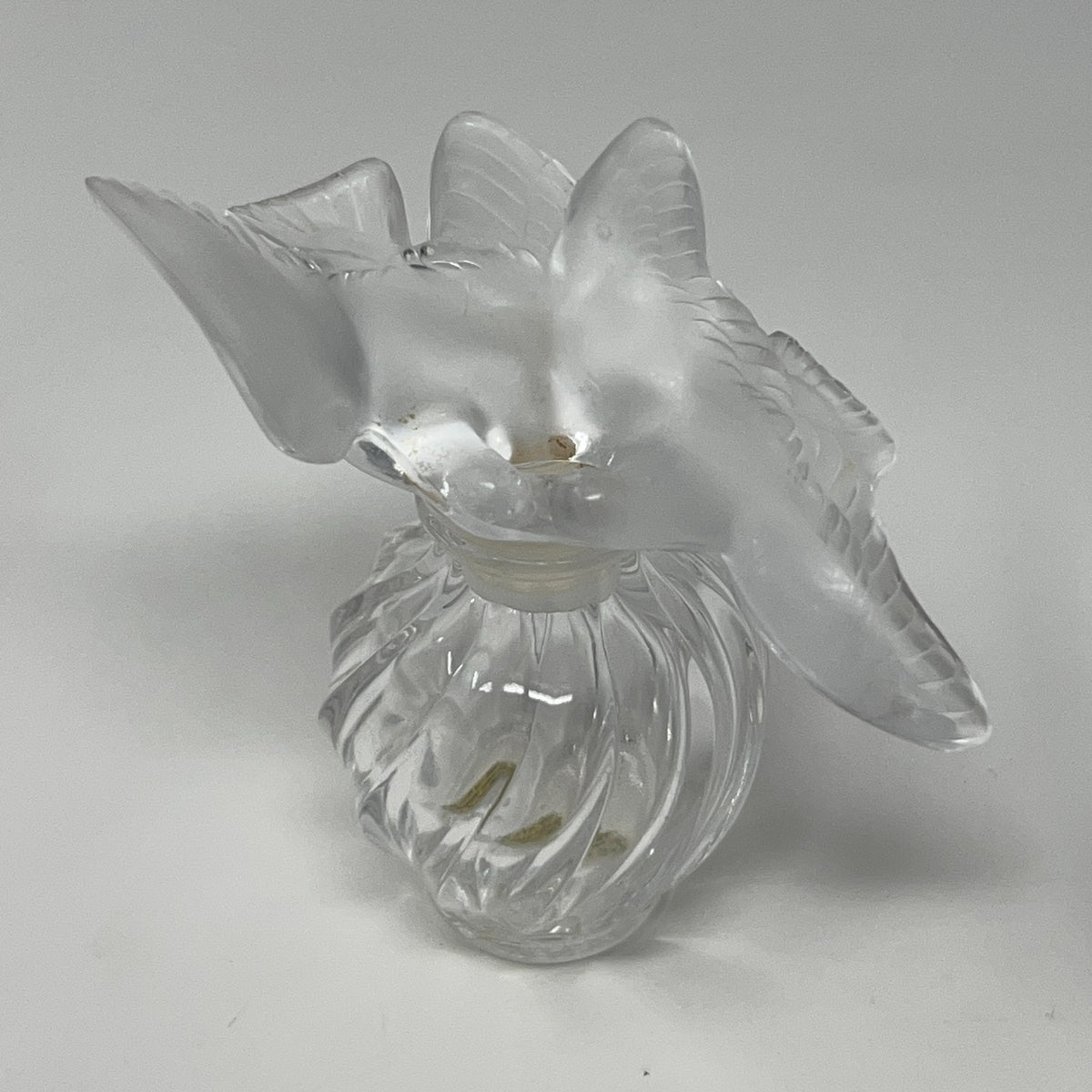 Nina Ricci floral glass perfume bottle with a frosted two doves top, viewed from above