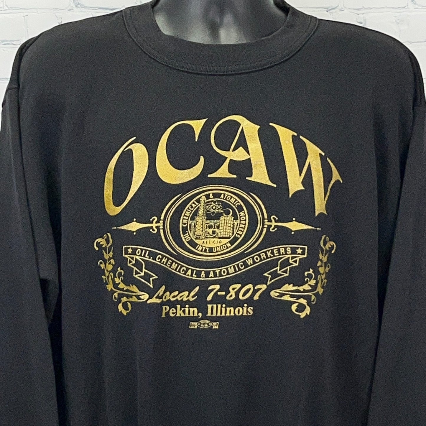 Black long-sleeve shirt featuring OCAW logo and Local 7-807 text, front view with detailed design