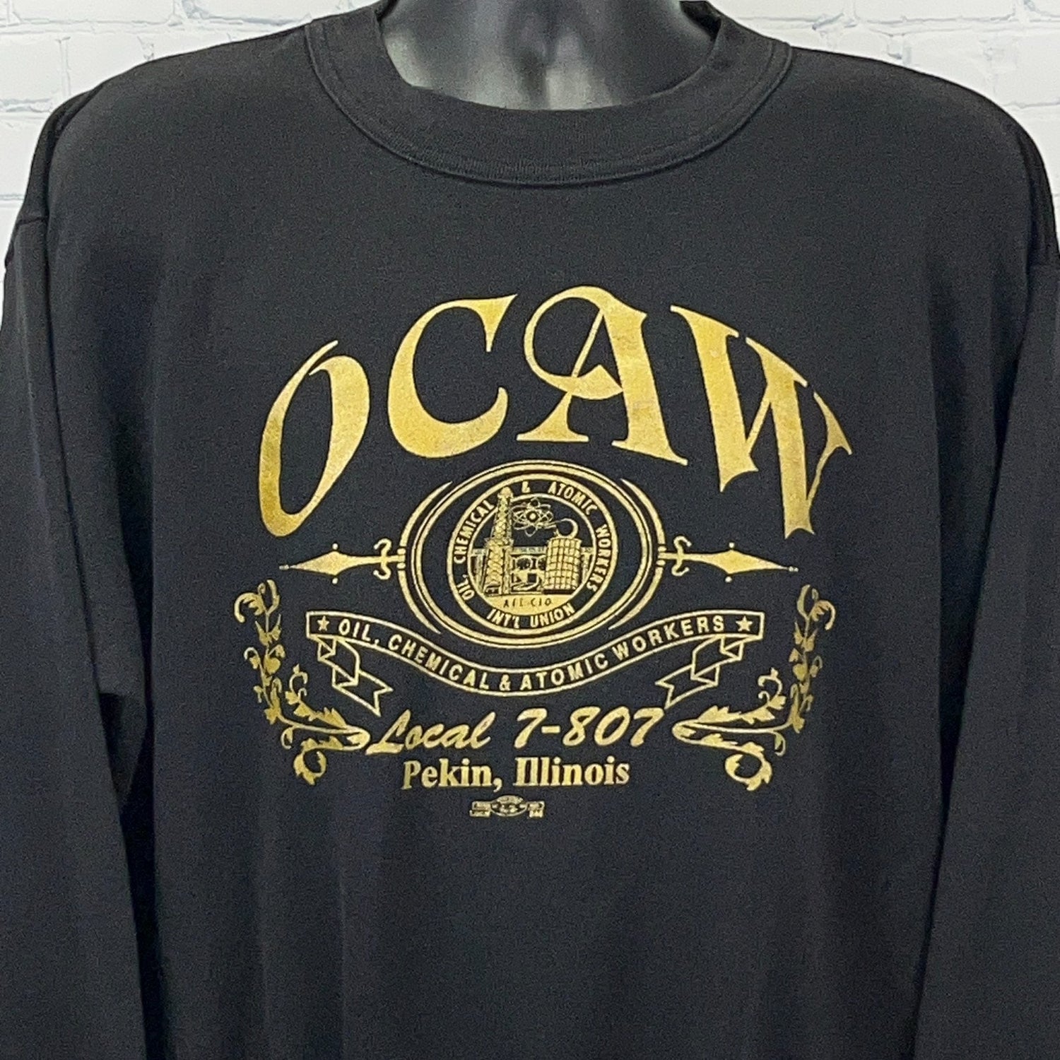 Black long-sleeve shirt featuring OCAW logo and Local 7-807 text, front view with detailed design