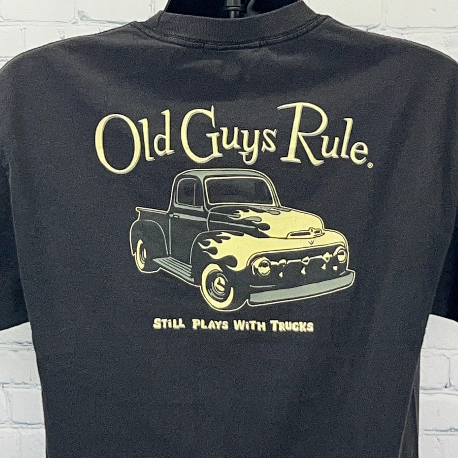 Black t-shirt featuring Old Guys Rule logo and vintage truck graphic, size displayed on mannequin