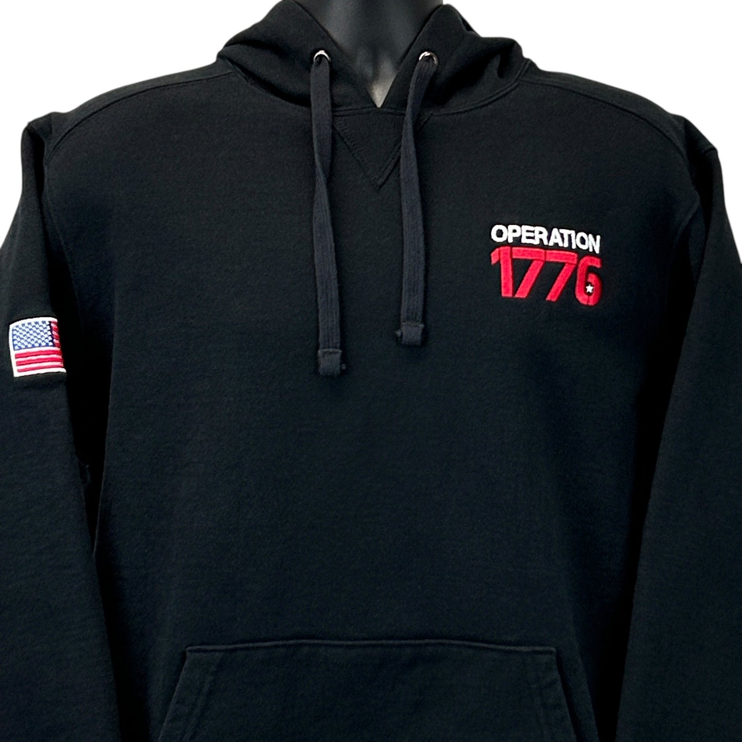 Black Volunteer Knitwear 1776 Hoodie with front view, featuring Operation 1776 logo and American flag patch