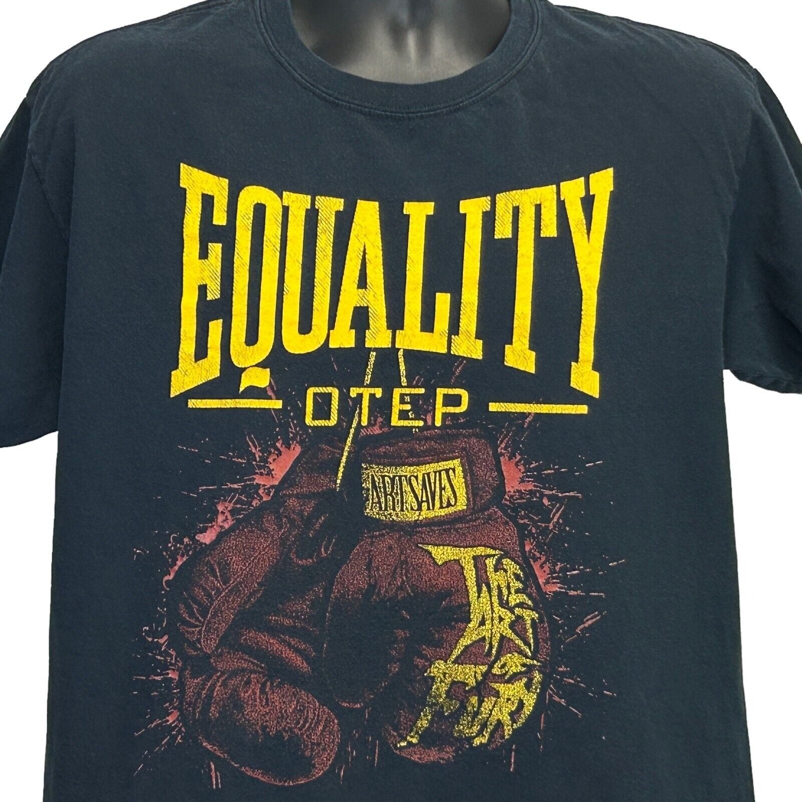 Black T-Shirt featuring bold yellow 'EQUALITY Otep' design with boxing gloves on the front