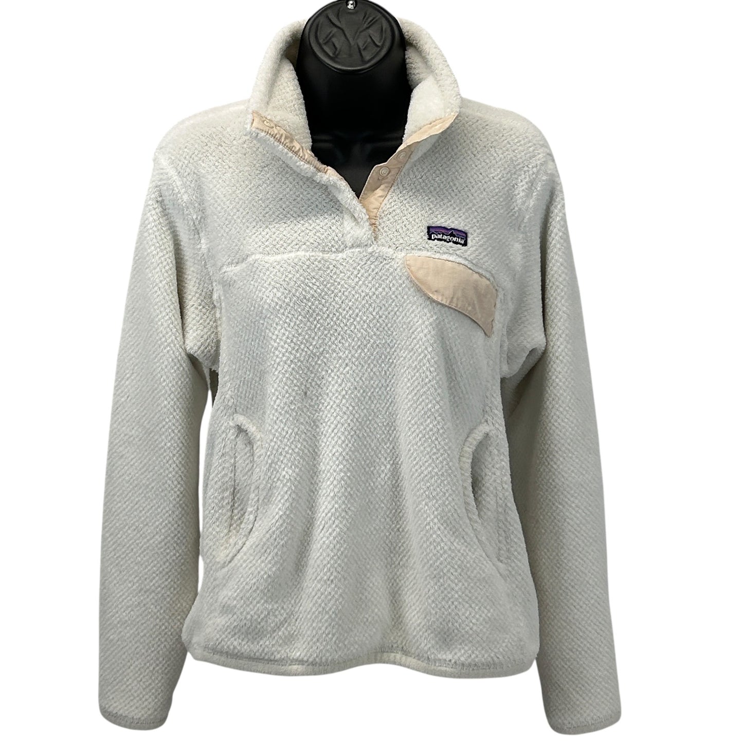 Patagonia fleece jacket in cream color with a front pocket and logo on the chest, size medium, front view